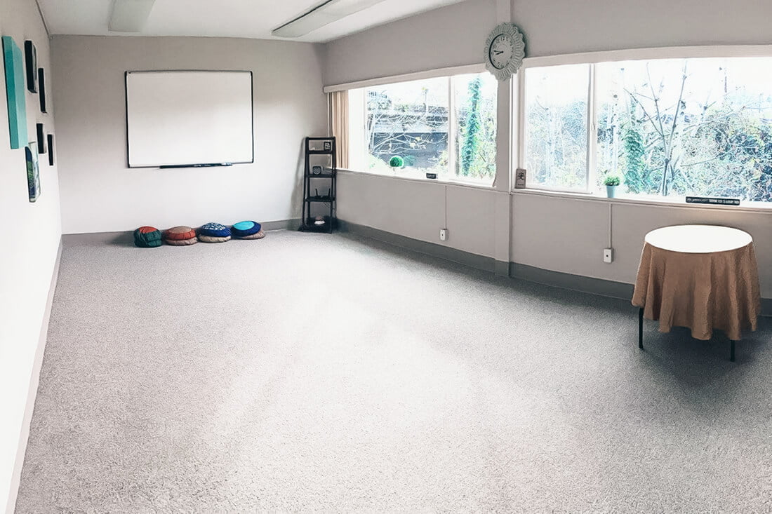 long empty room with a table and pouches