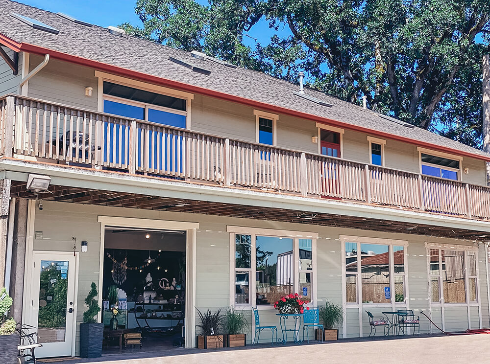 large deck on back of building with open garage-style doors