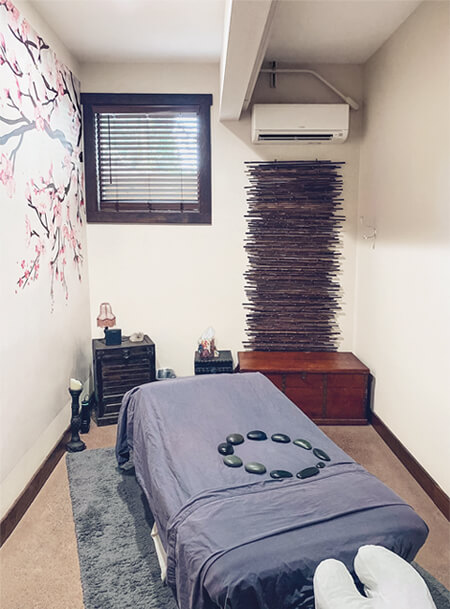 massage table in room with antique style furniture